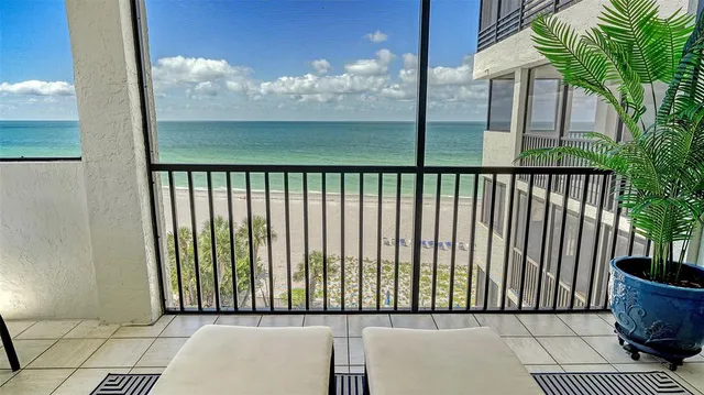 a dining room with furniture a chandelier and wooden floor