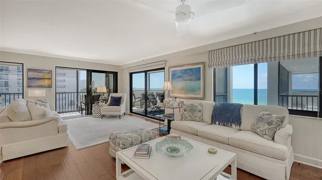 a bedroom with furniture and large windows