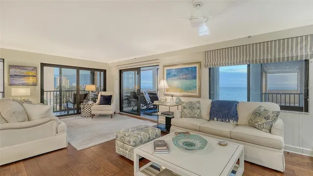 a living room with furniture and a floor to ceiling window