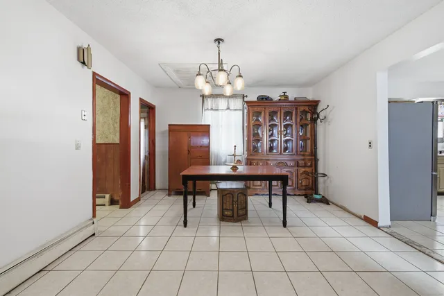 a view of a dining room with furniture and chandelier