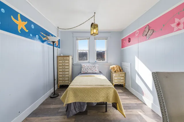 a bedroom with a bed and a large mirror