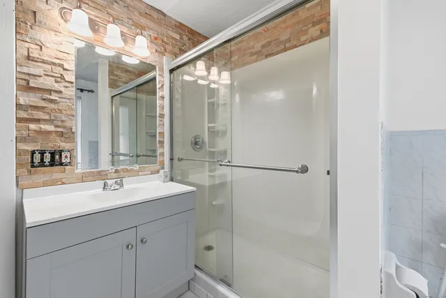 a bathroom with a sink a toilet and a window