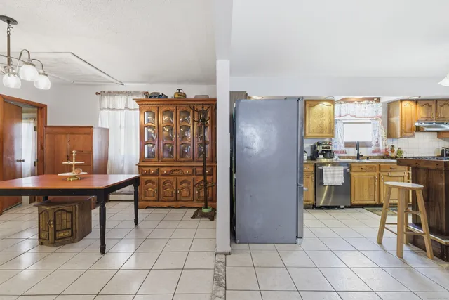 a kitchen with cabinets and refrigerator
