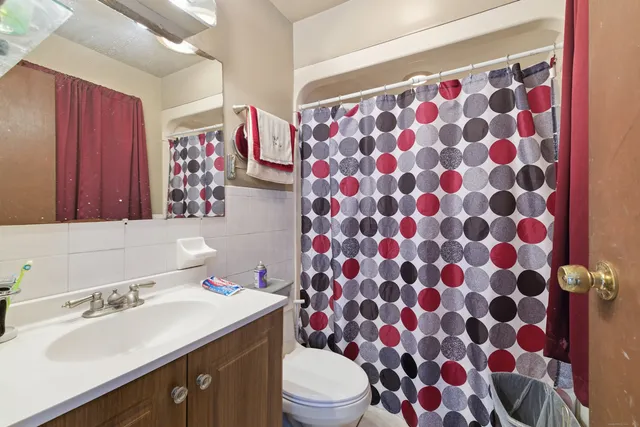 a bathroom with a sink toilet and shower