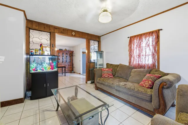 a view of a dining room with furniture and chandelier
