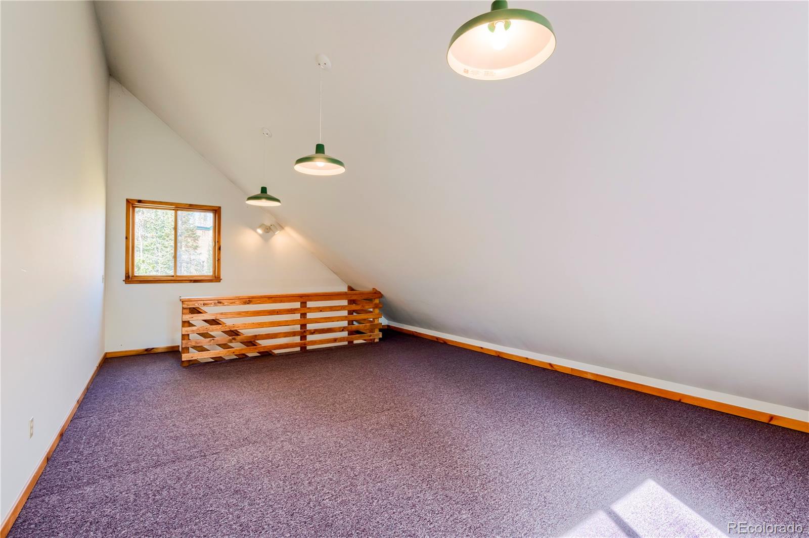 499 Kings Crossing Road Winter Park, CO 80482 - Photo 24 of 30 an empty room with windows and ceiling fan