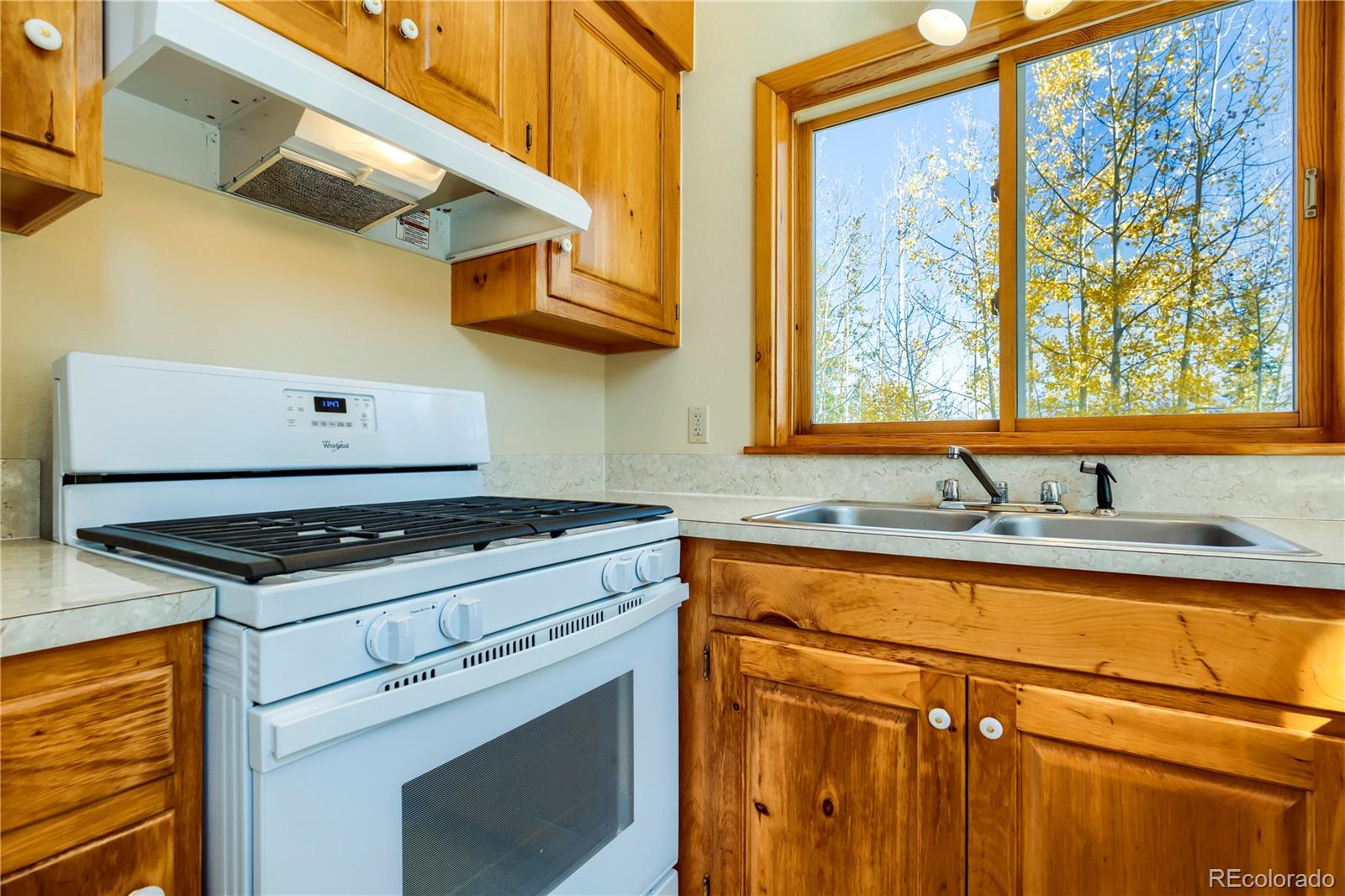 499 Kings Crossing Road Winter Park, CO 80482 - Photo 10 of 30 a kitchen with stainless steel appliances granite countertop a sink a stove and a microwave