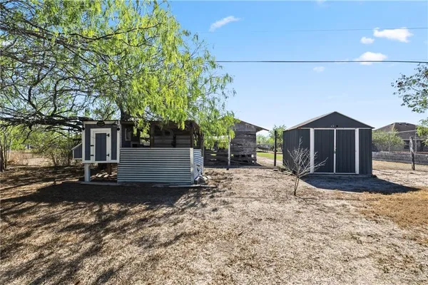 a view of a house with a yard and tree
