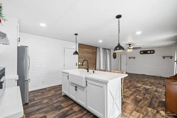 a kitchen with a sink appliances and cabinets