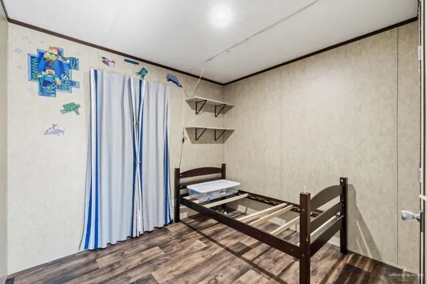 a view of a hallway with wooden floor and workspace