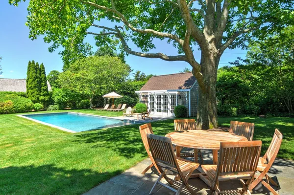 a view of a chairs and table in the garden