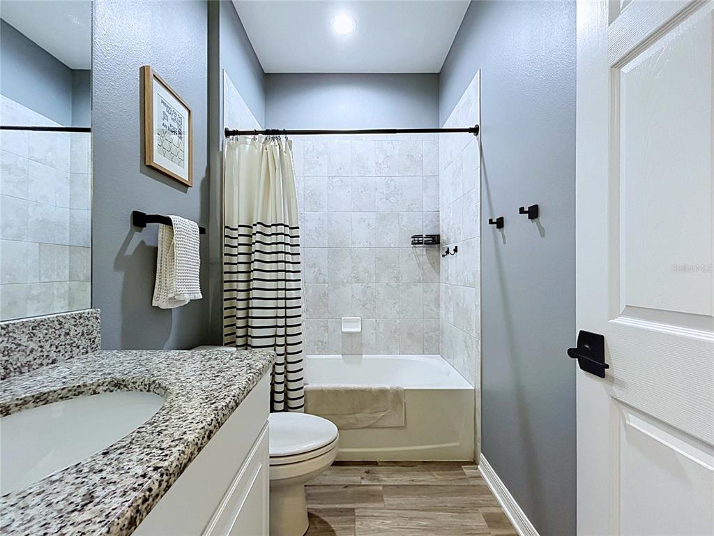 18078 Romanesque Court Spring Hill, FL 34610 - Photo 48 of 81 a bathroom with a granite countertop sink toilet and shower