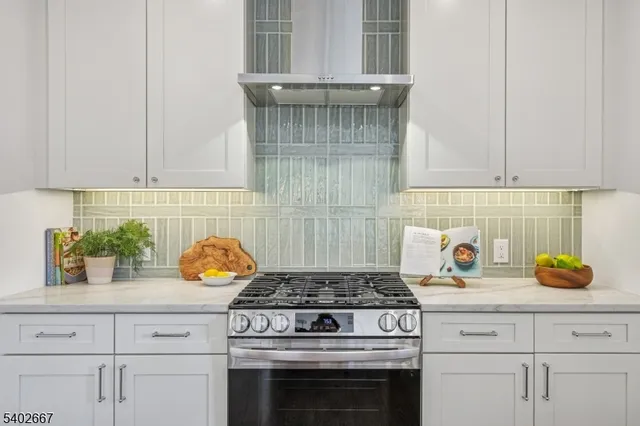 a stove top oven sitting inside of a kitchen