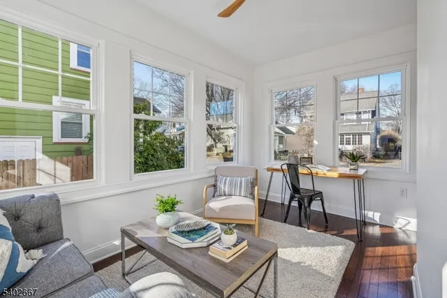 a living room with furniture and next to a window