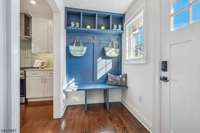 a view of a workspace with furniture and wooden floor