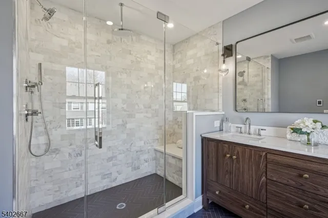 a bathroom with a double vanity sink mirror and shower