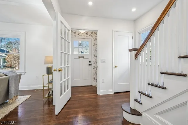 a view of entryway with wooden floor and stairs