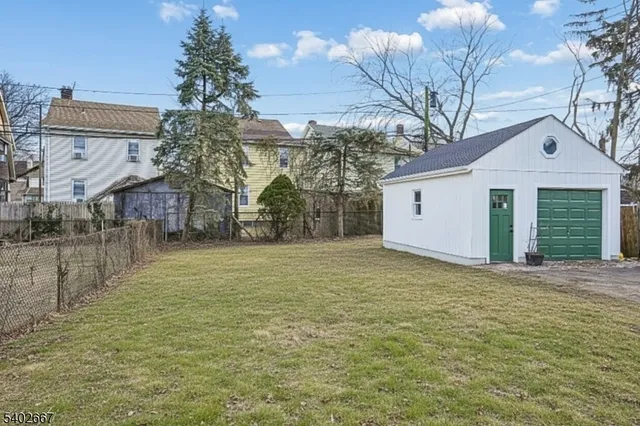 a view of a house with a yard and garage