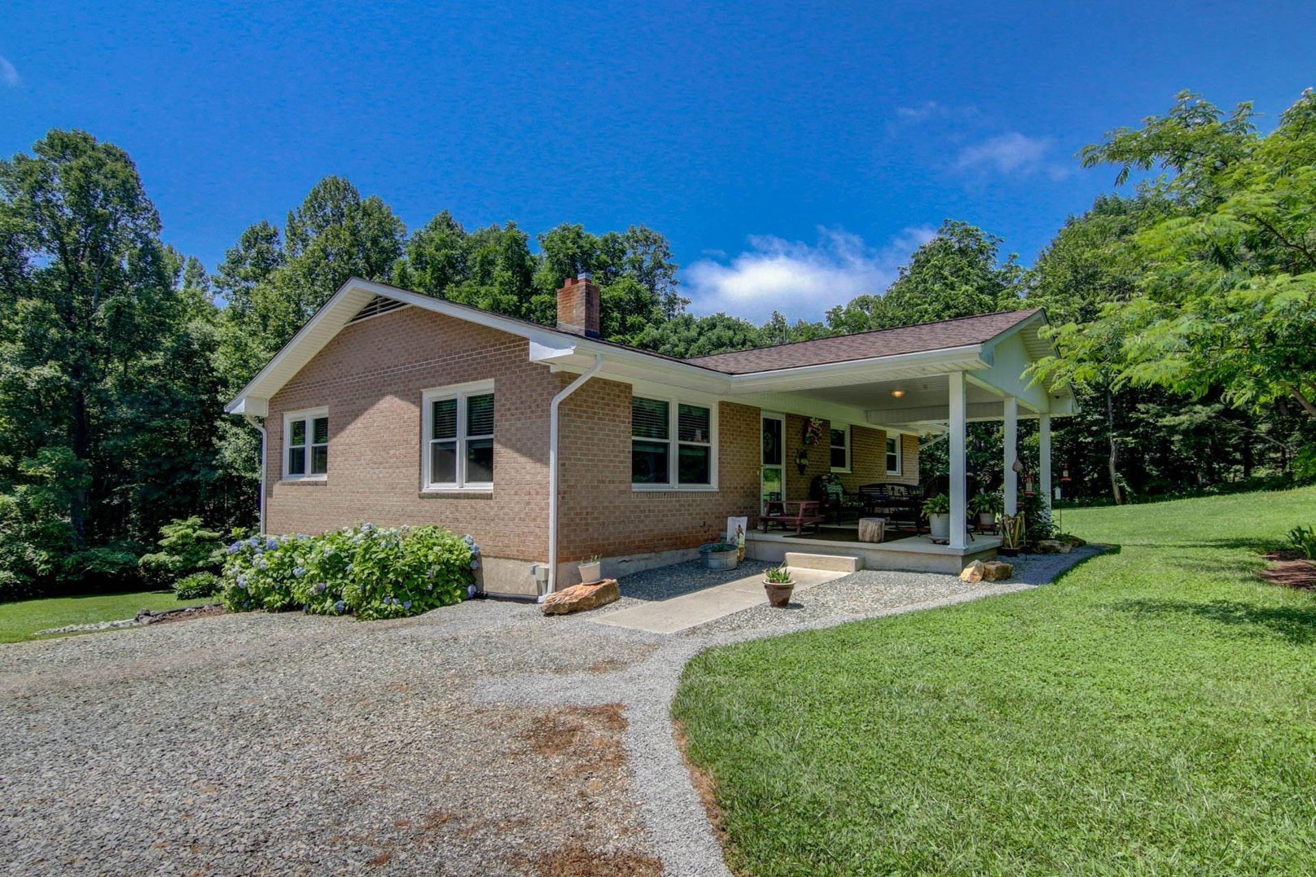 a view of a house with a yard and sitting area