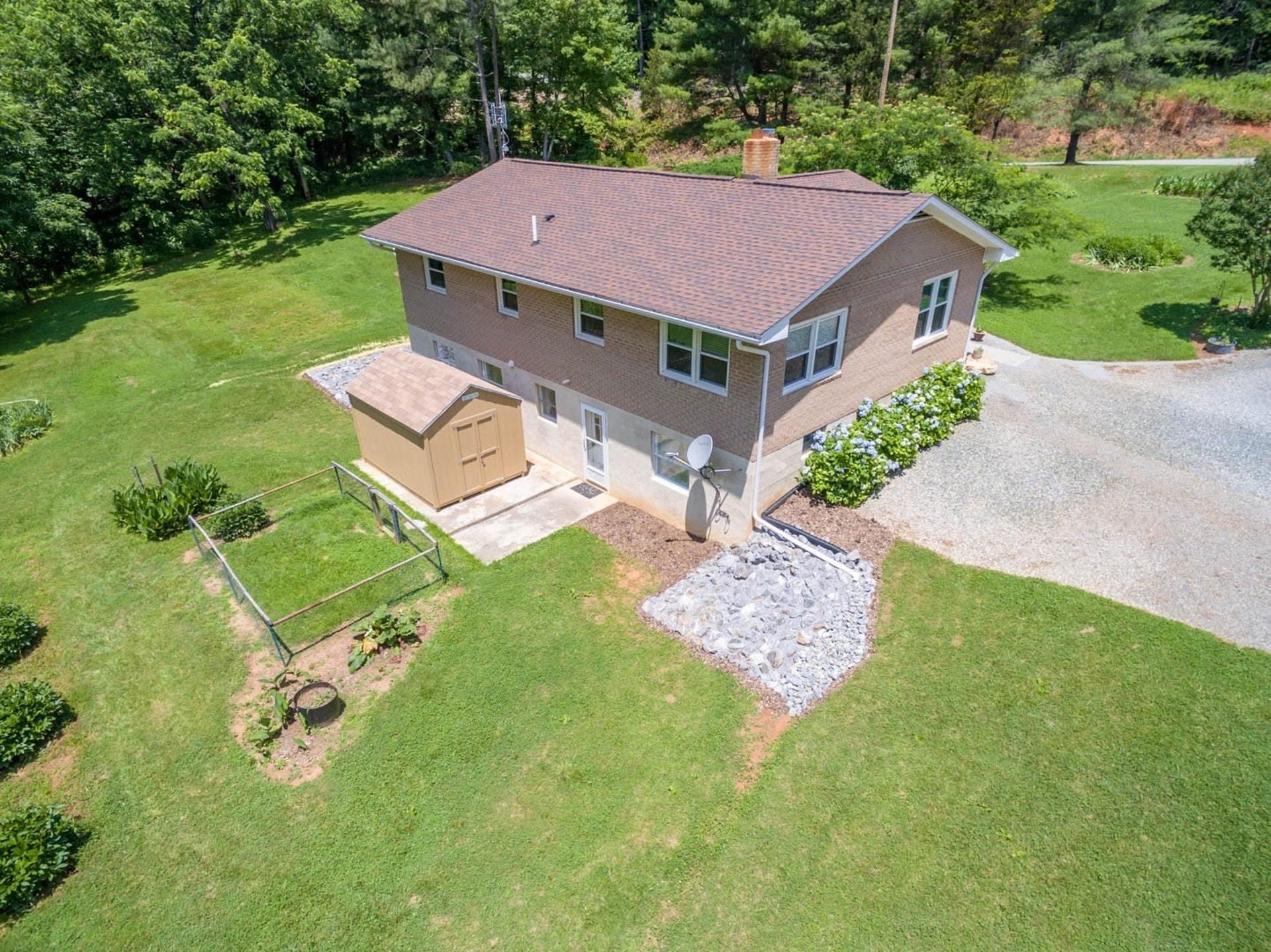 4682 Providence Church Road Ferrum, VA 24088 - Photo 2 of 43 a aerial view of a house with swimming pool garden view and trees