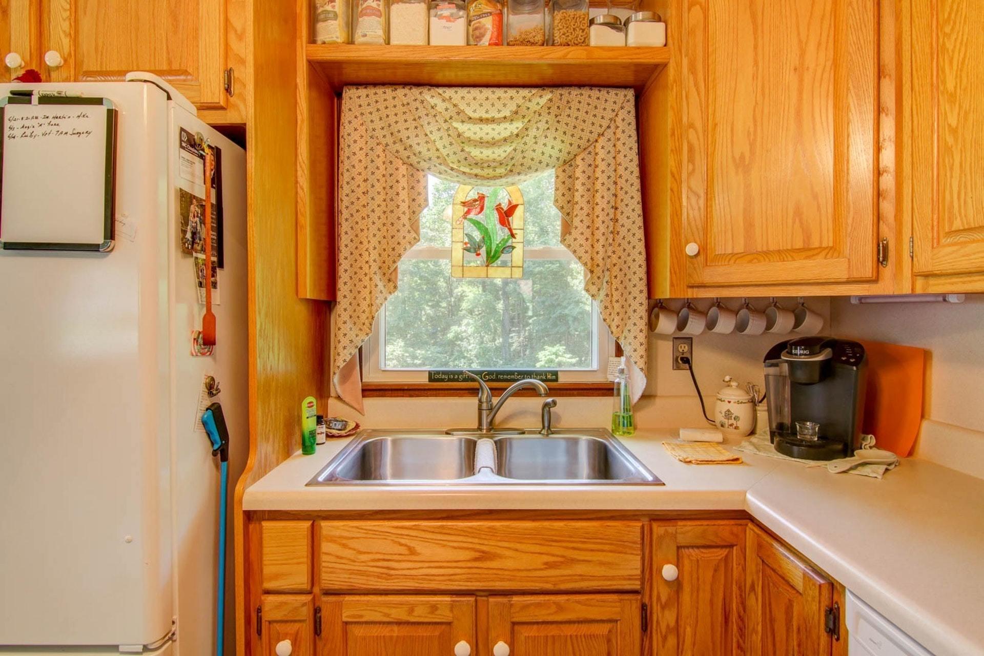 4682 Providence Church Road Ferrum, VA 24088 - Photo 15 of 43 a view of a sink and dishwasher next to a window