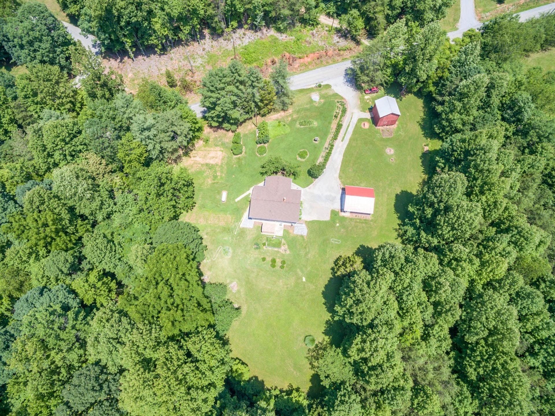 4682 Providence Church Road Ferrum, VA 24088 - Photo 42 of 43 an aerial view of residential house with outdoor space and trees all around