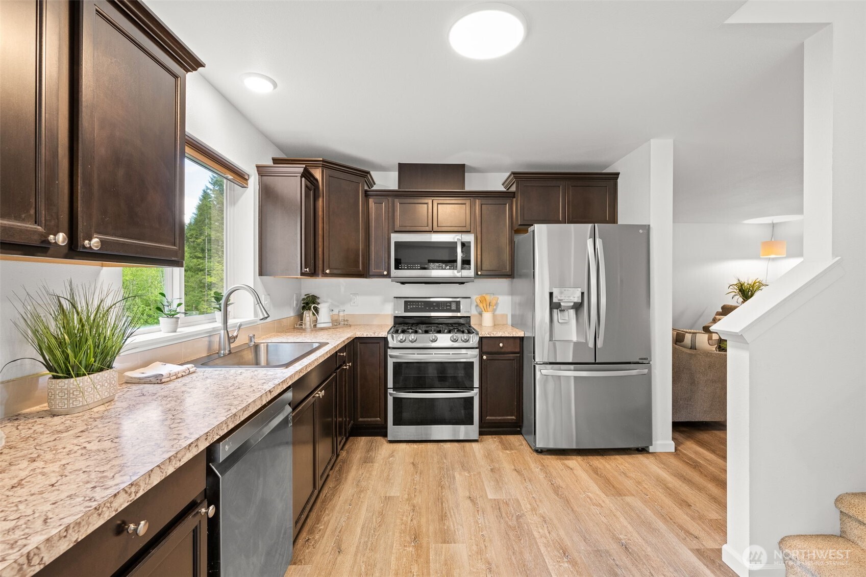 401 East Sunset Ridge Road Union, WA 98592 - Photo 7 of 37 a kitchen with kitchen island granite countertop a sink a counter space stainless steel appliances and cabinets