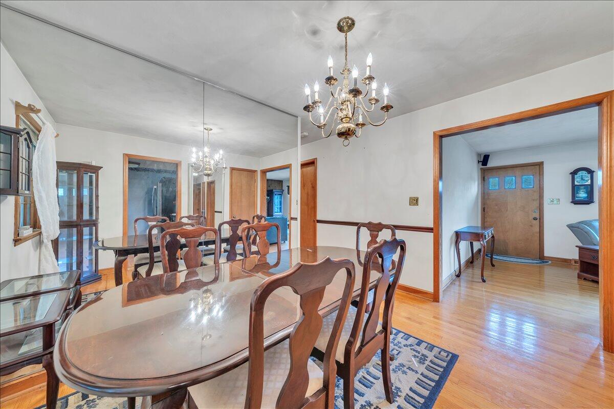 1525 West Ruritan Road Roanoke, VA 24012 - Photo 11 of 62 a dining room with furniture a chandelier and wooden floor