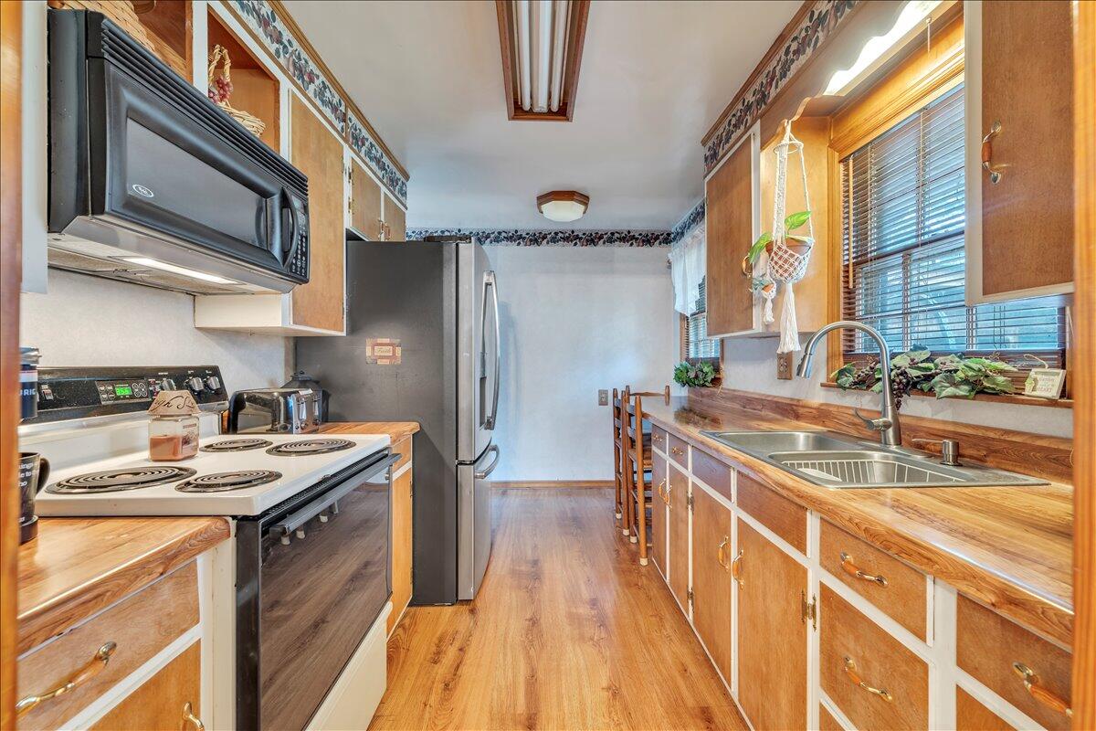 1525 West Ruritan Road Roanoke, VA 24012 - Photo 12 of 62 a kitchen with stainless steel appliances granite countertop a sink a stove and a refrigerator