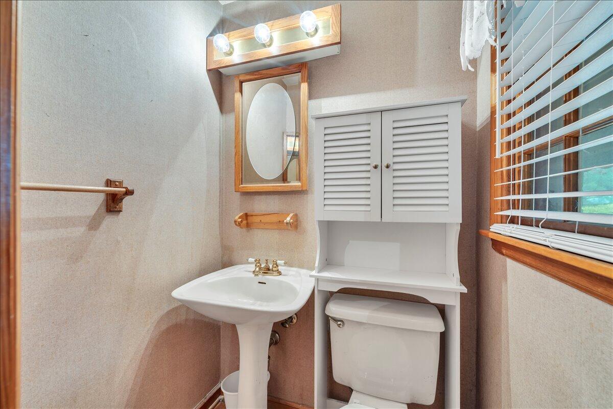 1525 West Ruritan Road Roanoke, VA 24012 - Photo 25 of 62 a bathroom with a sink a mirror and a toilet