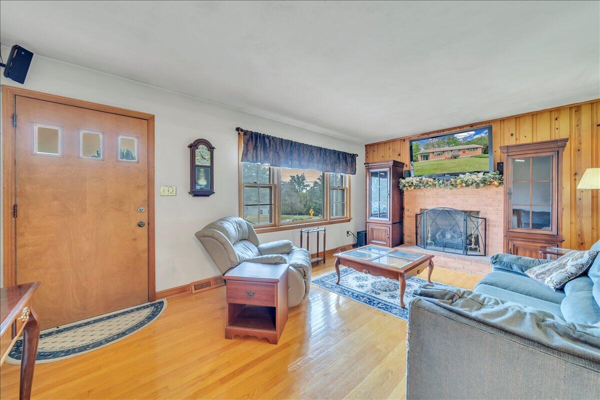 1525 West Ruritan Road Roanoke, VA 24012 - Photo 6 of 62 a living room with fireplace furniture and a large window