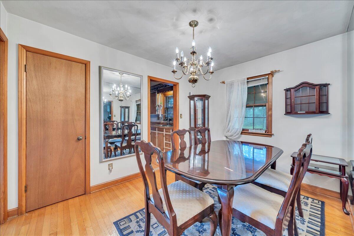 1525 West Ruritan Road Roanoke, VA 24012 - Photo 10 of 62 a view of a dining room with furniture wooden floor and a chandelier