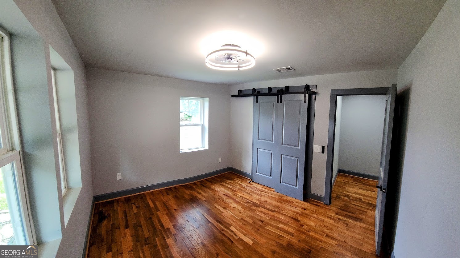 1285 Dallas Highway Villa Rica, GA 30180 - Photo 8 of 9 a view of an empty room with wooden floor and a window