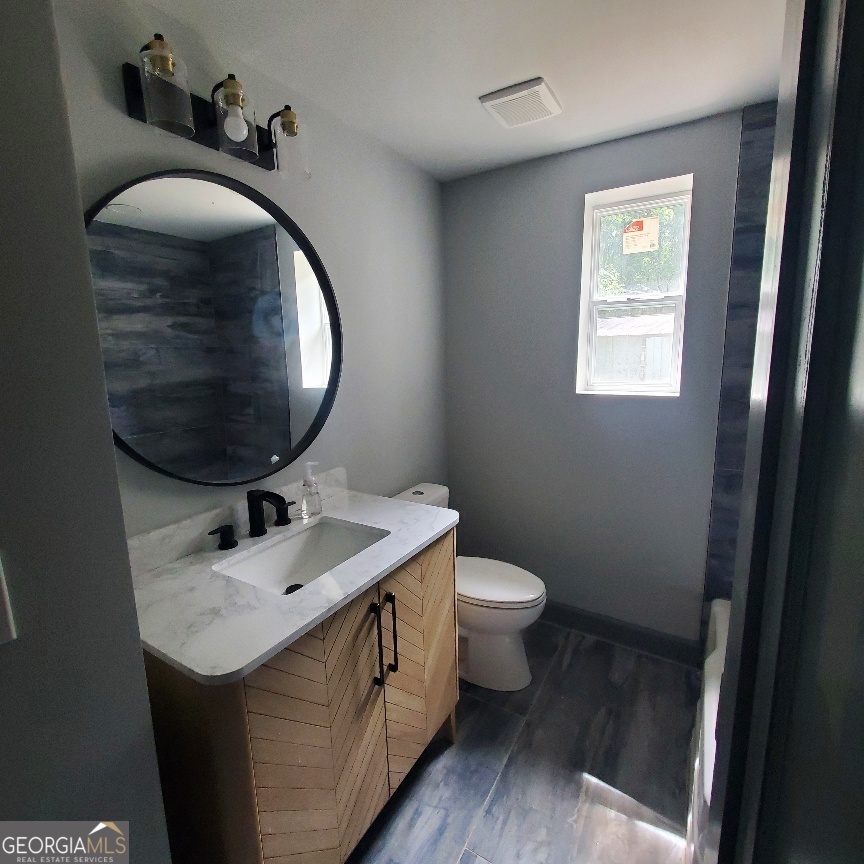 1285 Dallas Highway Villa Rica, GA 30180 - Photo 9 of 9 a bathroom with a sink toilet and a mirror
