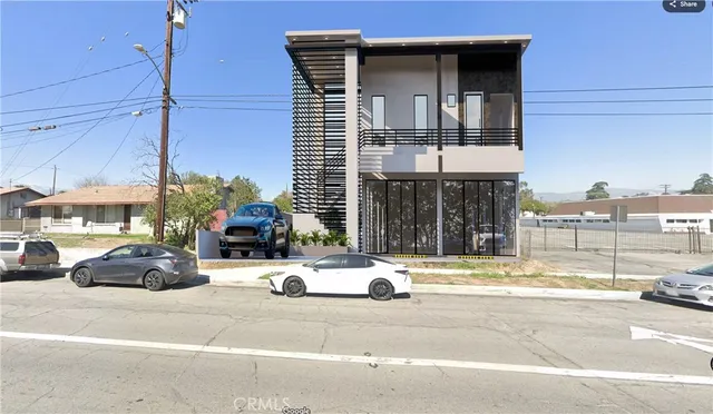 a view of building with car parked