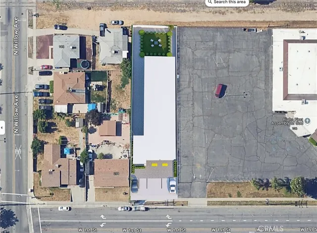 an aerial view of residential houses with outdoor space and parking