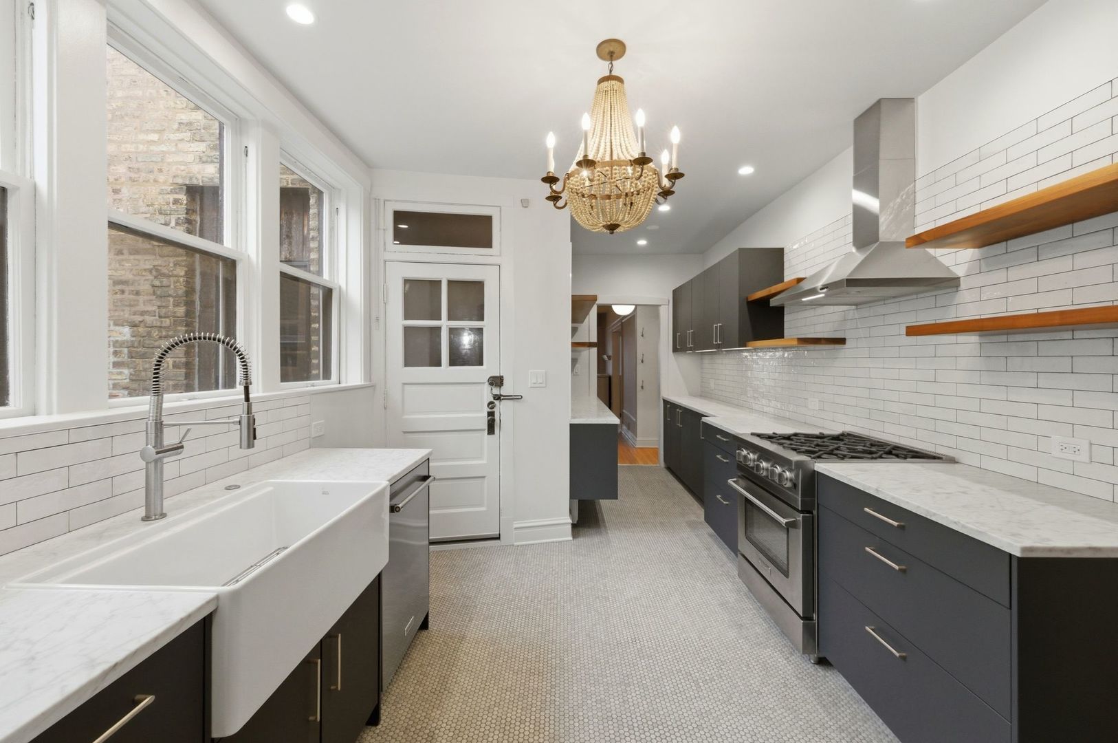 540 Sheridan Road, Unit 3 Evanston, IL 60202 - Photo 12 of 25 a kitchen with stainless steel appliances a sink stove and cabinets