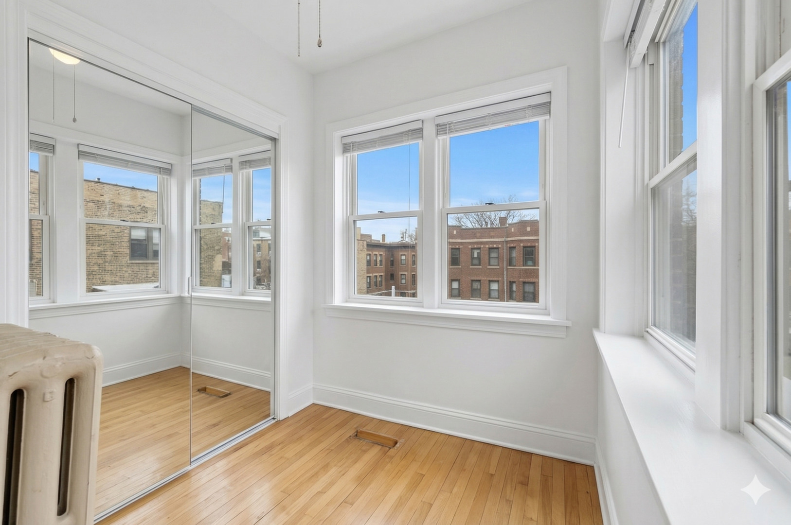 540 Sheridan Road, Unit 3 Evanston, IL 60202 - Photo 19 of 25 a view of an empty room with wooden floor and a window