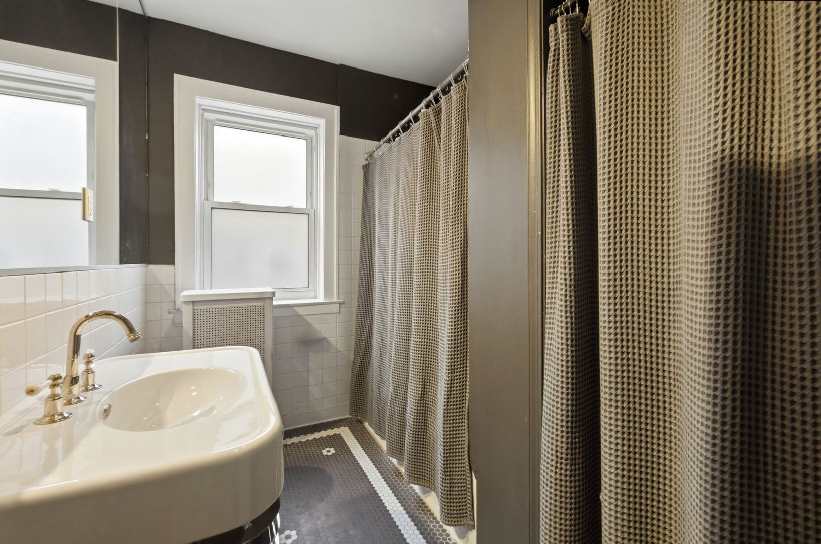 540 Sheridan Road, Unit 3 Evanston, IL 60202 - Photo 22 of 25 a bathroom with a sink a mirror and a shower