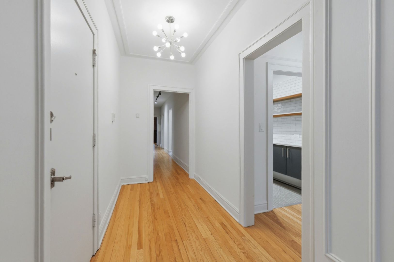 540 Sheridan Road, Unit 3 Evanston, IL 60202 - Photo 5 of 25 a view of a hallway with wooden floor and staircase