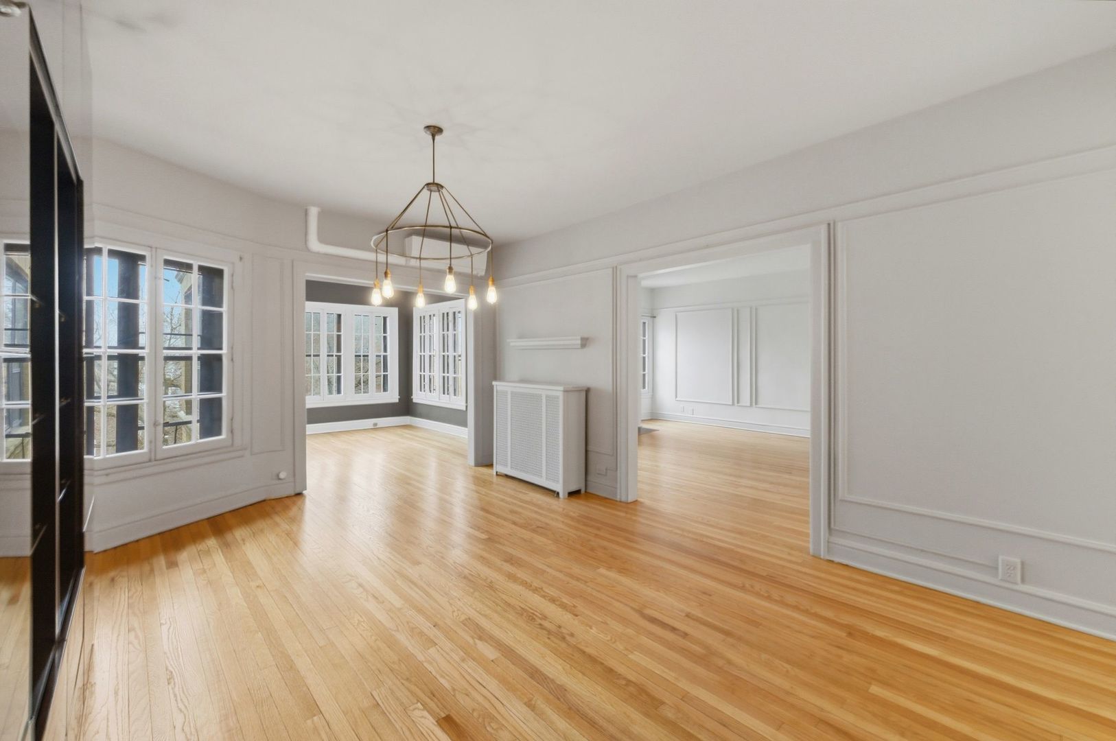 540 Sheridan Road, Unit 3 Evanston, IL 60202 - Photo 7 of 25 a view of an empty room with wooden floor and a window