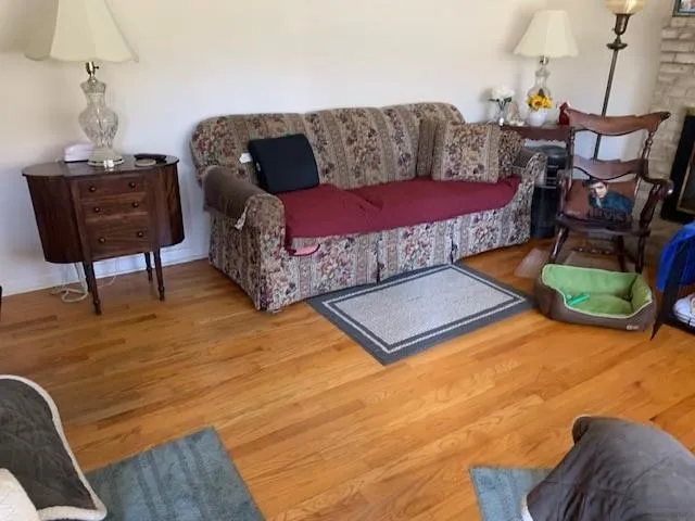 a view of a room with wooden floor