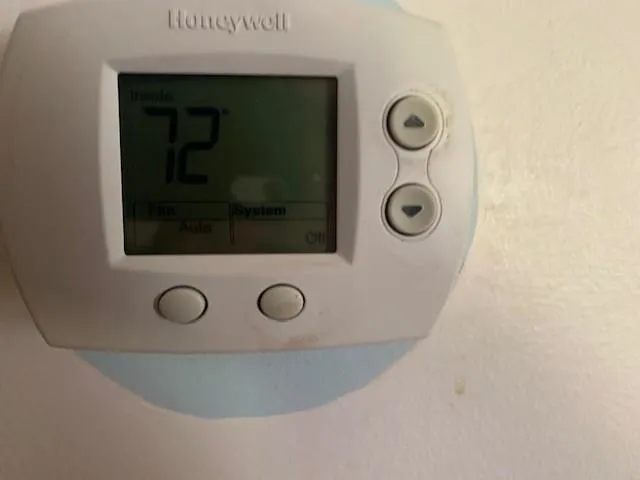 a bathroom with a toilet and a shower curtain