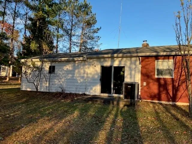 a view of backyard with wooden fence