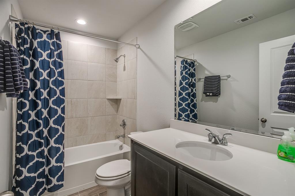 9912 Mescalbean Boulevard Crowley, TX 76036 - Photo 18 of 23 a bathroom with a sink a toilet and shower