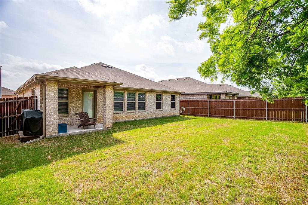 9912 Mescalbean Boulevard Crowley, TX 76036 - Photo 23 of 23 a front view of a house with a garden