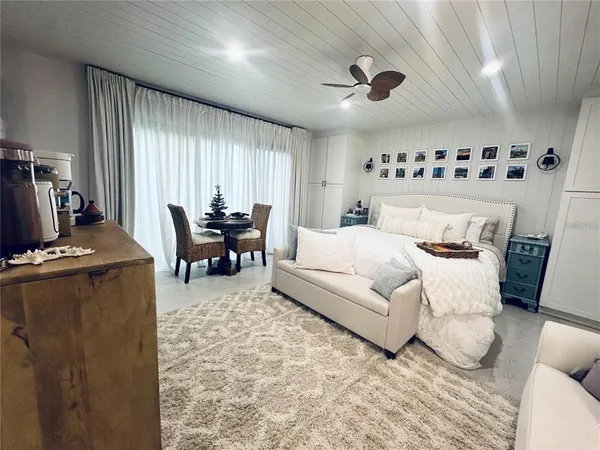 a bedroom with furniture and large windows