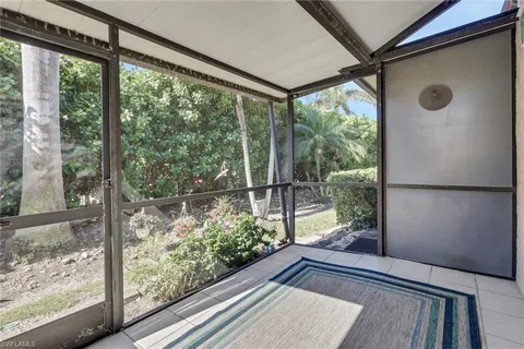 a view of a room with wooden floor and windows