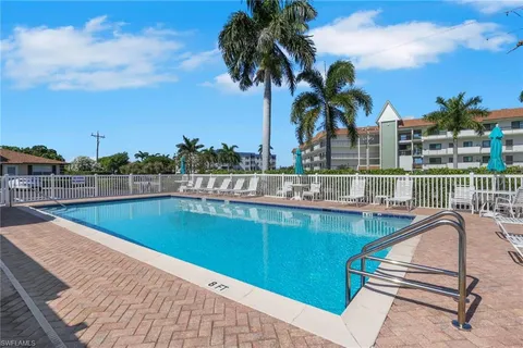 a view of a swimming pool with a lounge chair