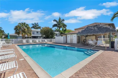 a view of a house with swimming pool and sitting area
